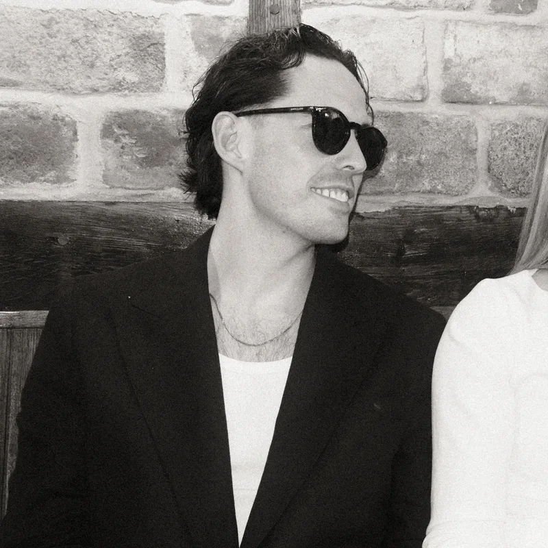 AJ, Creative at Studio Nude, in sunglasses at a wedding